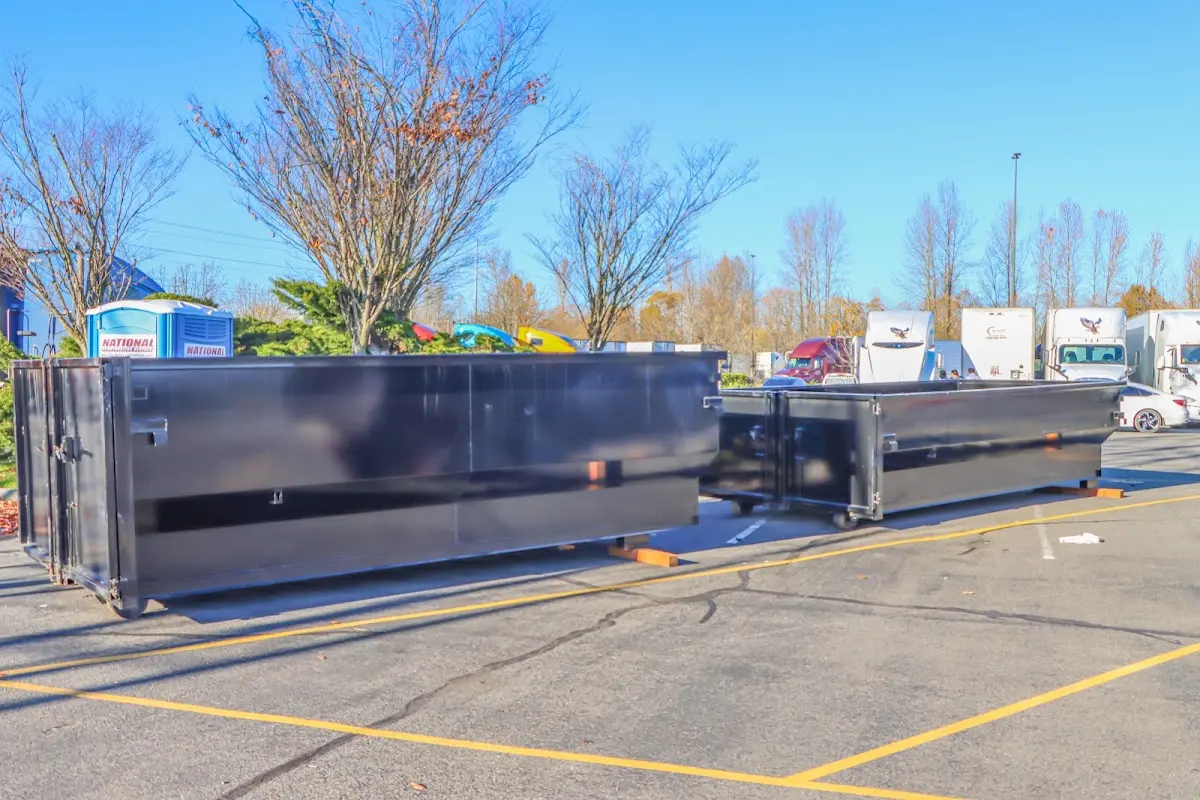 Professional dumpster rental service with roll-off container on residential driveway in Annapolis